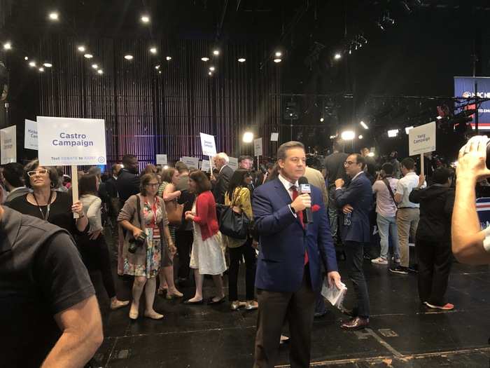 As the media waited for candidates and surrogates to make their way over from the debate hall to the Spin Room, campaign staff held up signs with the candidate