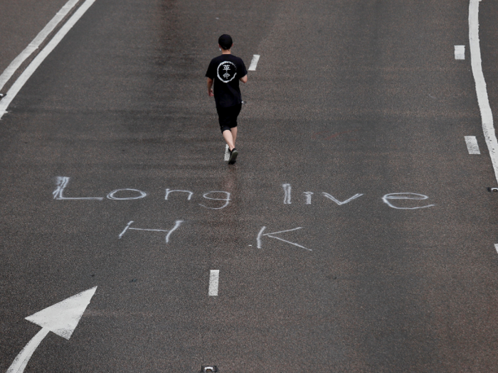 Here, a protester wearing a t-shirt with the words 