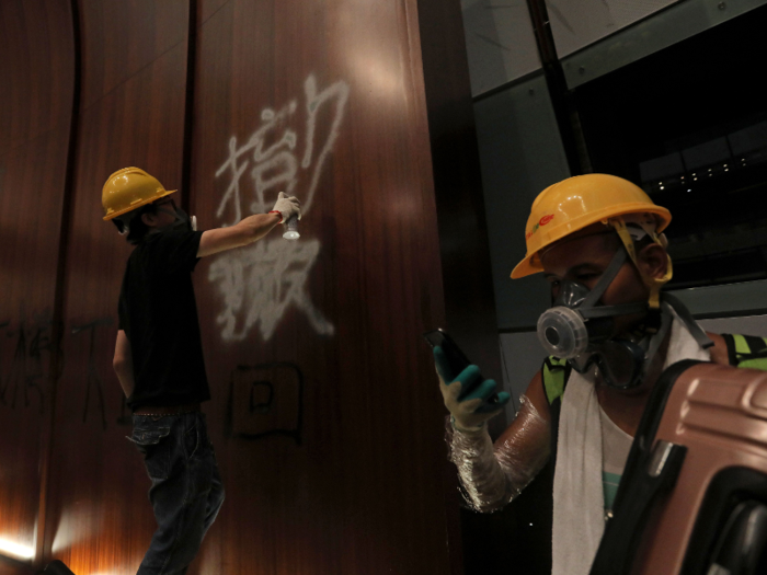 Other protesters spray painted the chamber walls with graffiti slogans such as "release the righteous fighters" and "we want genuine universal suffrage."