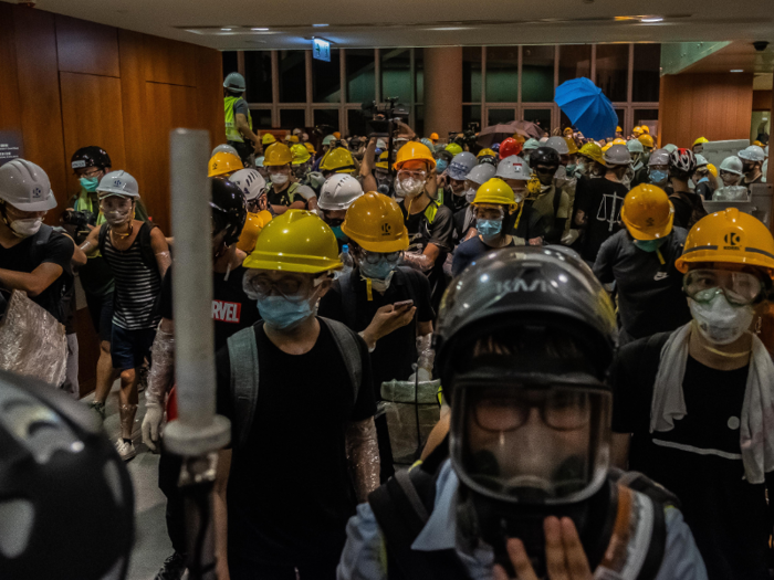 Police appeared to back off as the protesters entered the building, in an attempt to avoid a violent confrontation.