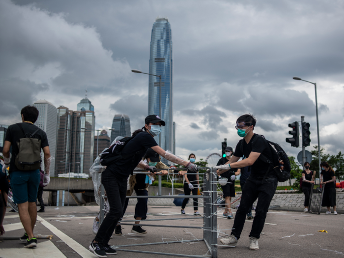 Protesters in face masks and dressed in black moved metal barricades down the street.