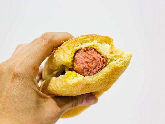 A juicy, flavorful dog enveloped in a fluffy, slightly sweet bun with a hint of texture. I