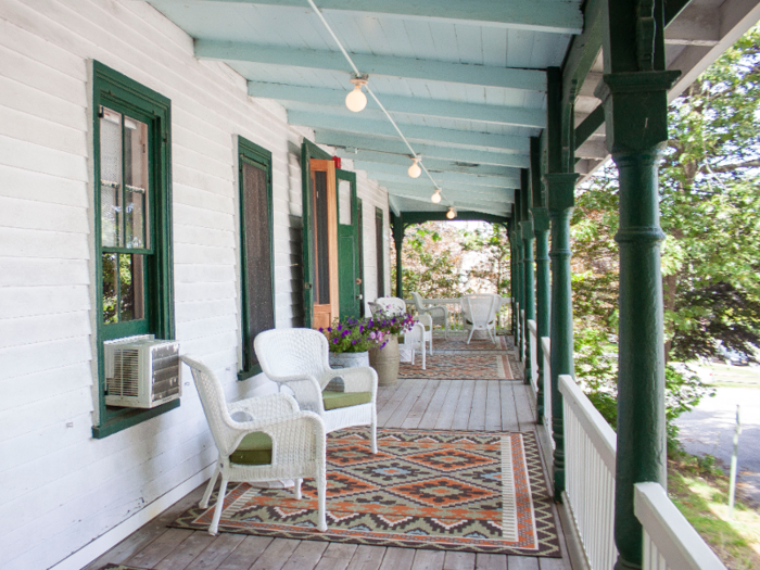 A shared porch shaded by trees faces the main Chequit building.