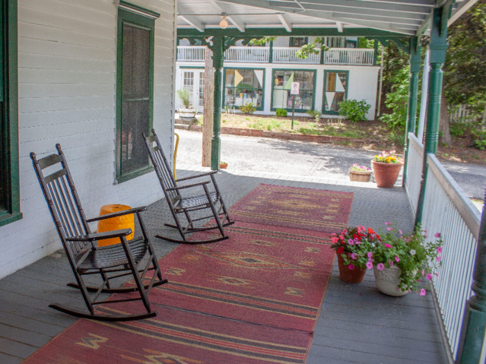 The rocking chairs on the front porch give off a whimsical, retro vibe as guests approach the entrance to reception.