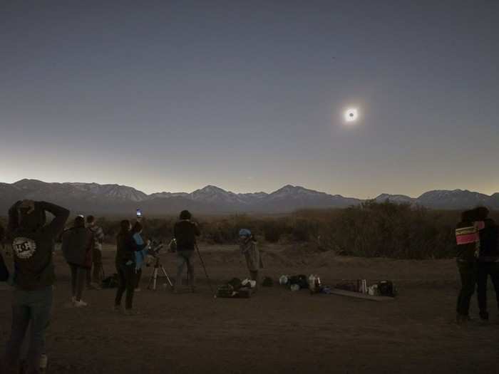 People camped out with blankets and telescopes in the riverside town of Bella Vista in Argentina.