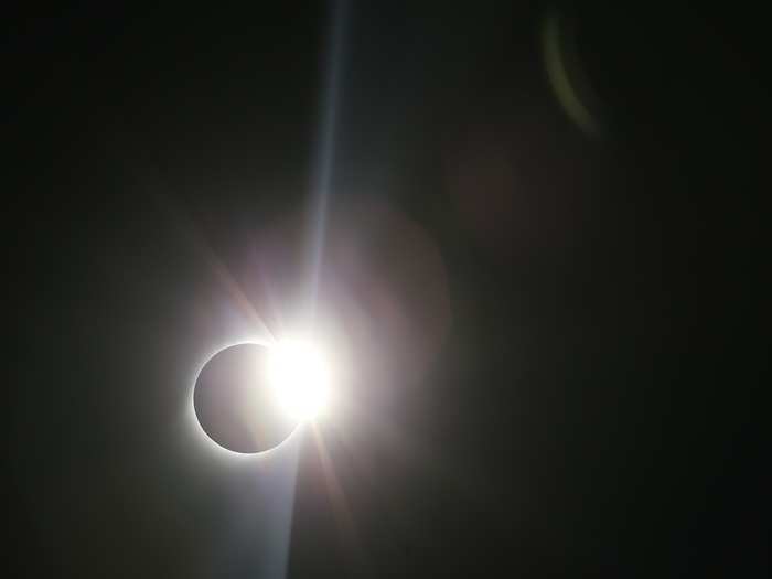 The eclipse began as the moon moved between the sun and the Earth, casting its shadow across the Earth