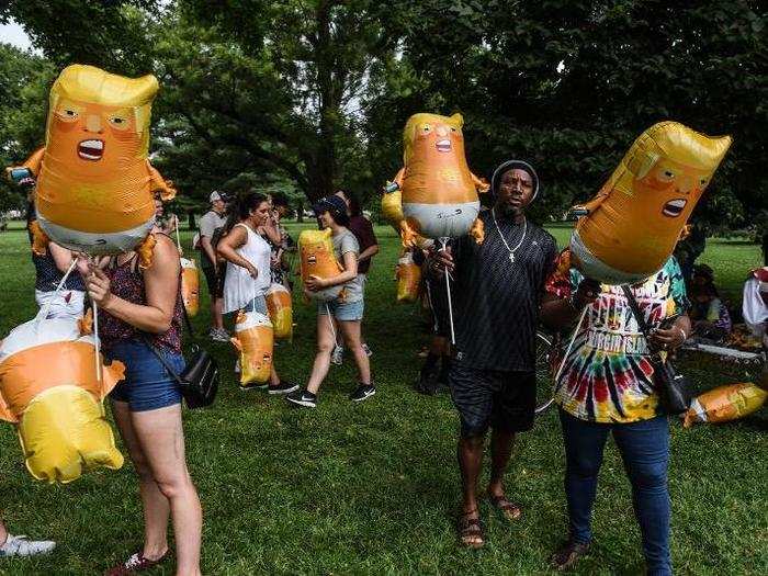 Meanwhile, protesters with the organization Codepink handed out small, foil balloons resembling Trump in a diaper.