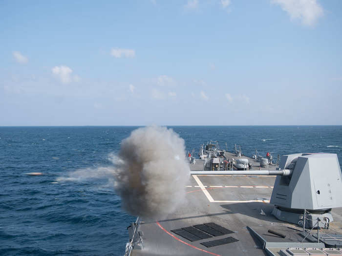 The mount, which has an automatic loader drum, is fired remotely, and it can launch 16 to 20 conventional rounds a minute to a range of just under 15 miles. Destroyers can hold up to 600 conventional rounds.