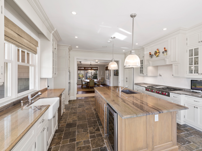 The spacious, farmhouse-style kitchen is divided by a large island.