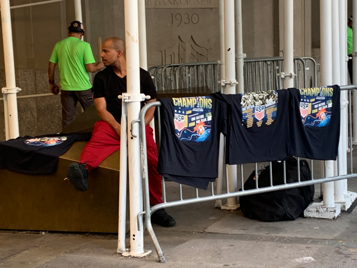 A man was selling shirts commemorating the world champions a full 24 hours before the parade.