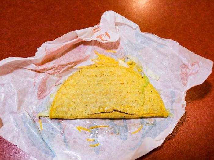 The hard corn tortilla was slightly cracked on the bottom, and the meat juices had soaked through slightly.