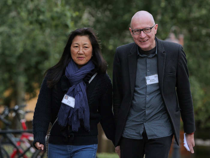 Wang Ping (left) walks with spouse Robert Thomson (right), CEO of News Corp.