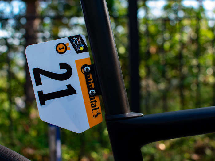 Each rider has a number plate attached to his seat post. Alaphilippe is rider No. 21. The No. 3 represents the number of stage wins he has in the Tour in his career.