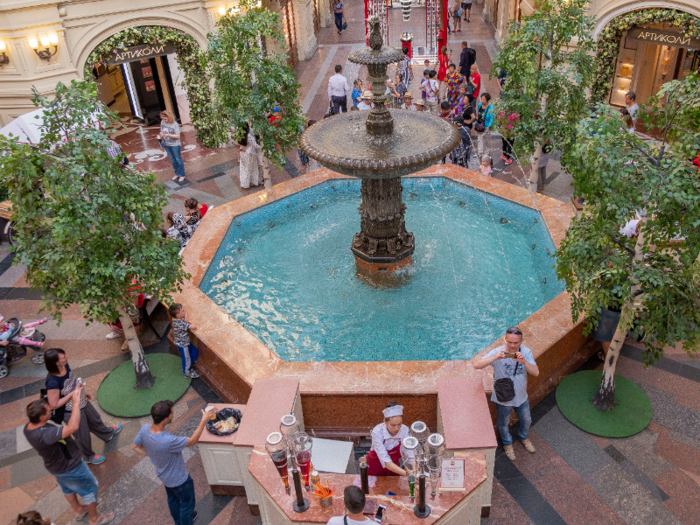 A fountain anchors the center of the shopping center ...