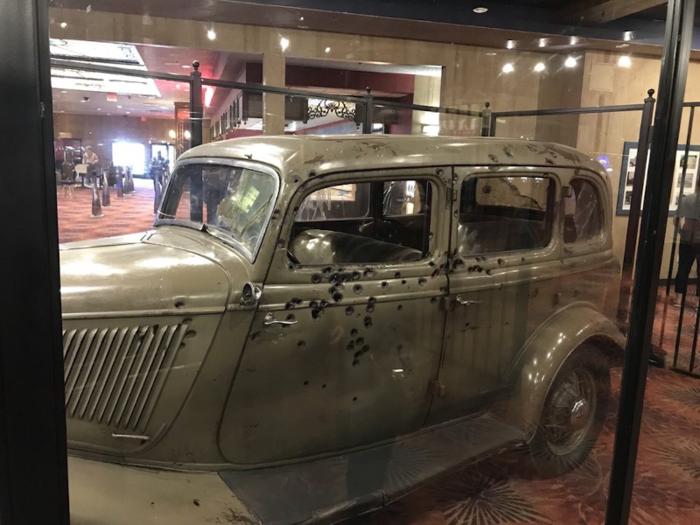 Glass panels surround the riddled car within Whiskey Pete