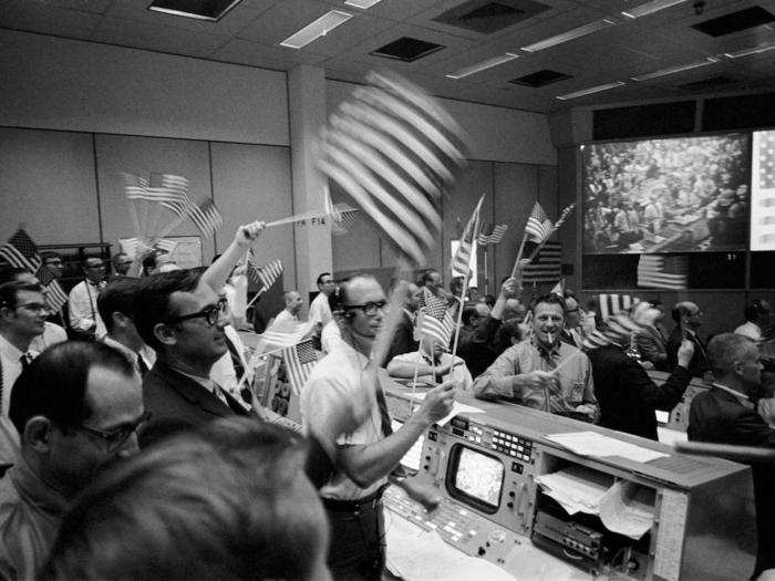 The flight controllers in that room waved American flags as the Apollo 11 astronauts splashed down safely on Earth on July 24, 1969.