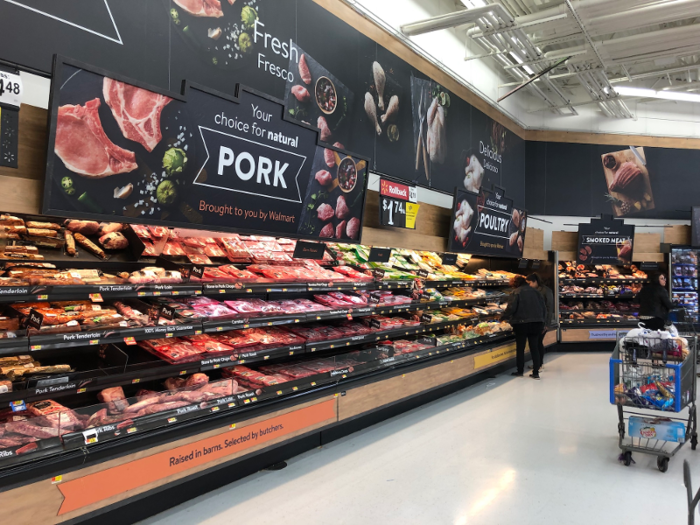 The meat and fish sections at Walmart in the US were stocked as well. The wall was separated into sections labeled ground beef, pork, poultry, and seafood.