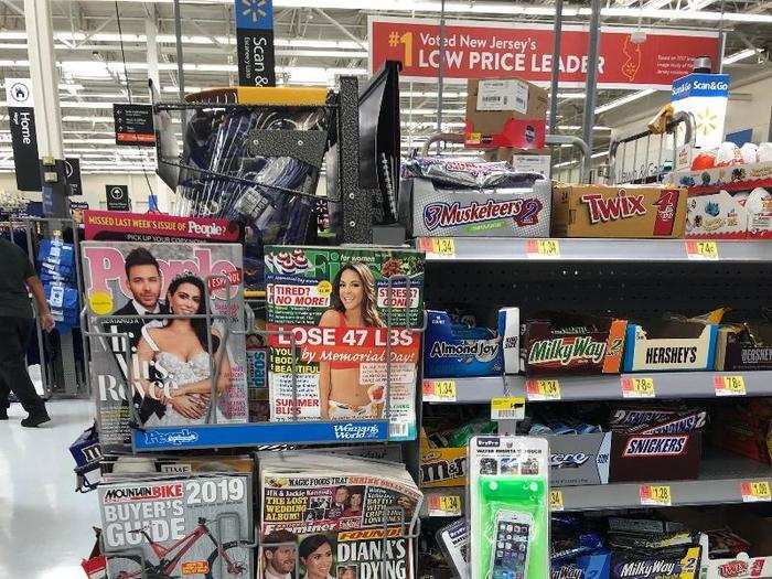 The magazines and tabloids at Walmart in the US were all lined up by the checkout stations.