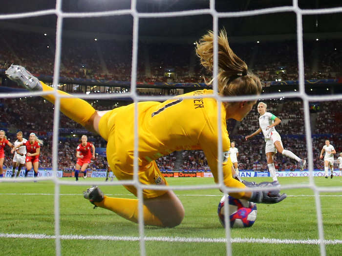 ... and rush toward Alyssa Naeher with her teammates after she stopped a penalty kick taken by England.