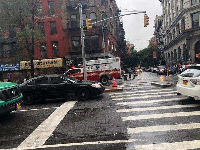 There were scattered police cars, fire trucks, and ambulances along the street of the pop-up location.