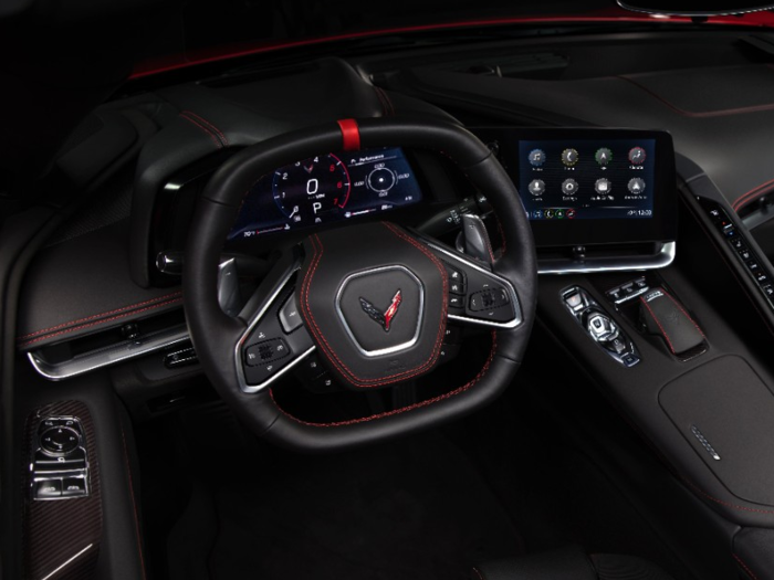 The squarish, two-spoke steering wheel is racing-derived and intended to provide a clear view of the digital cluster.