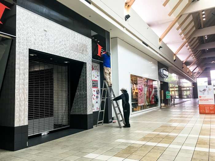 We saw a sign being stripped down from a shuttered, empty store.