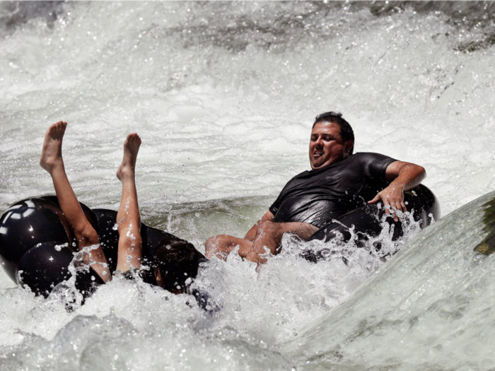 Surviving the heat gets a little more adventurous in Texas. Seen here are two people enjoying the Guadalupe River.