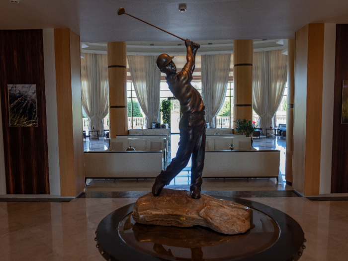 Inside the club, a statue of a golfer in mid-swing greets residents just past the reception desk.