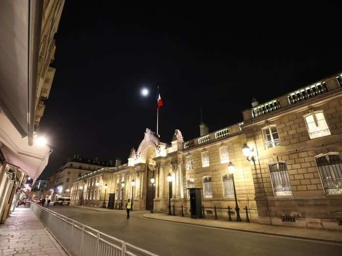 The palace sits at Number 55 on Rue du Faubourg Saint-Honoré, a public street in central Paris. The main building is secured behind a series of gates and walls.