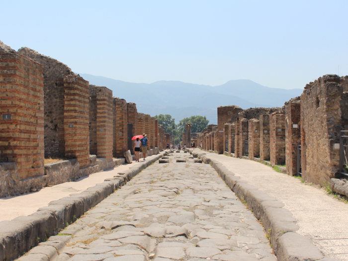 They also had a sneakier, more lucrative purpose. Michele told us that because of the distance between each stone, foreign carts would not have the right dimensions to pass between them. Therefore, they would have to pay a Pompeiian driver once they reached the city to transport their goods within. You can still see the grooves made by wheels in the road today.