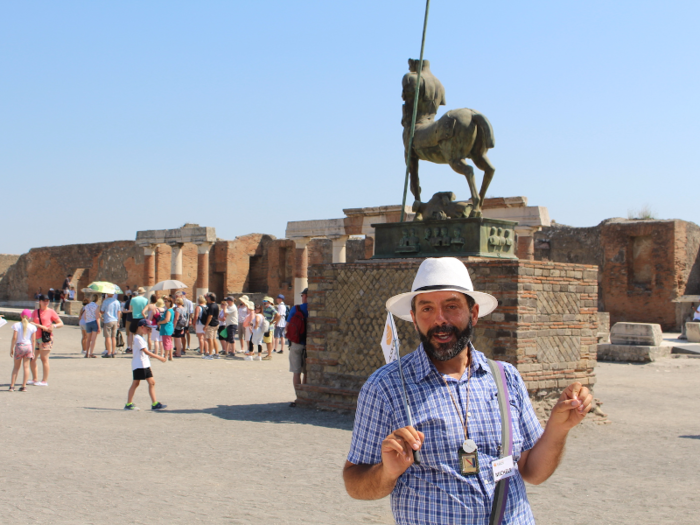 The forum is also home to some artwork. That statue behind Michele is not a period artifact, but a piece of modern art designed by Polish-French artist Igor Mitoraj who passed away in 2014.