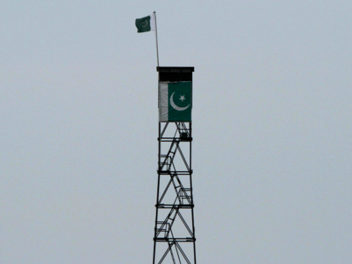 A Pakistani flag is visible on a guard tower on the Pakistani side of the border between Indian Kashmir and Pakistani Kashmir.