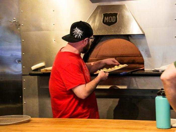 The oven at MOD is a simple metal machine. The pizza is slid off the pan into the hot oven and retrieved by a long pizza paddle.