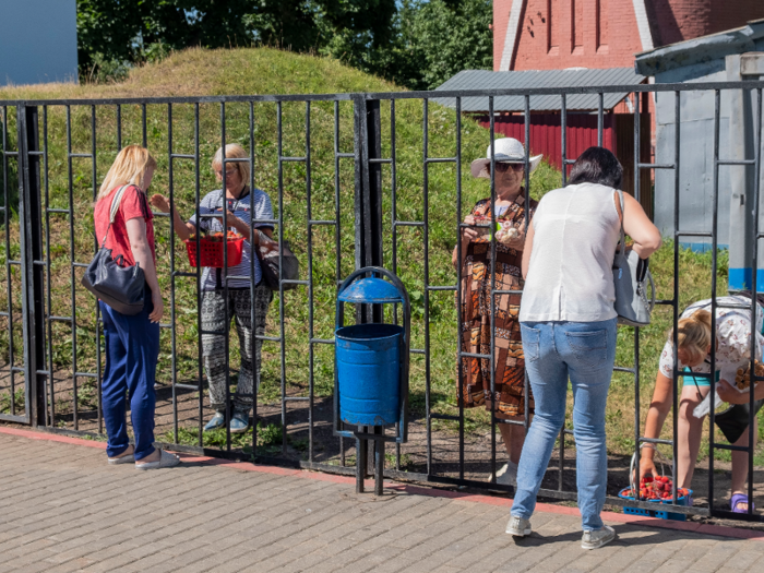 Local women were selling fresh strawberries and cherries on the other side of the train station gate.