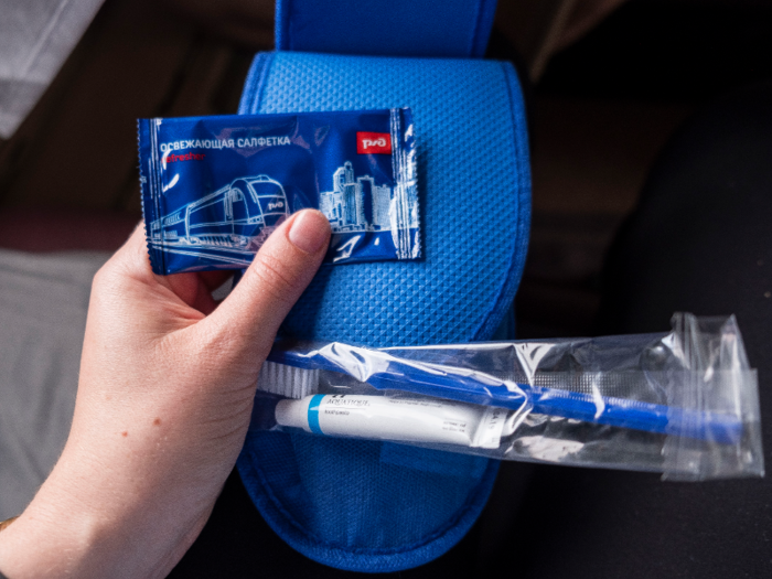 The attendant also handed out a hygiene kit that included a pair of flimsy blue slippers, a toothbrush, toothpaste, and a wet wipe.