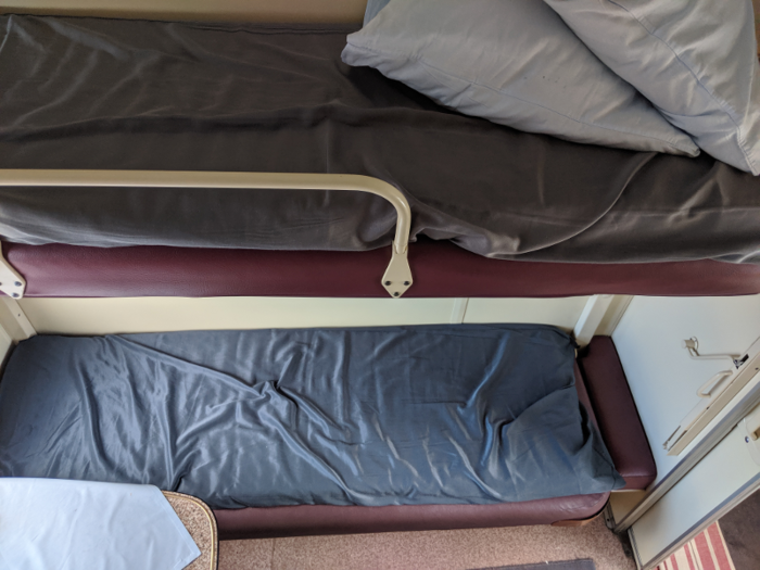 The bunks in our compartment were a little wider than half the size of a twin bed. Near the door, small ladders unfolded to allow the upper bank passenger to climb up. Even with the ladder, clambering up to my bunk wasn