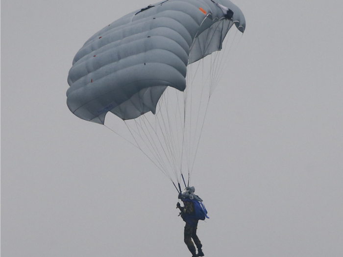 According to Russian state media, the Russian military is developing the D-14 Shelest parachute system, which will allow soldiers to access their weapons and begin firing immediately after they jump out of a plane.