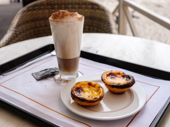 But no trip to Portugal is complete without picking up a Pasteis de Nata from a local pastry shop, a Portuguese custard tart dusted with cinnamon.