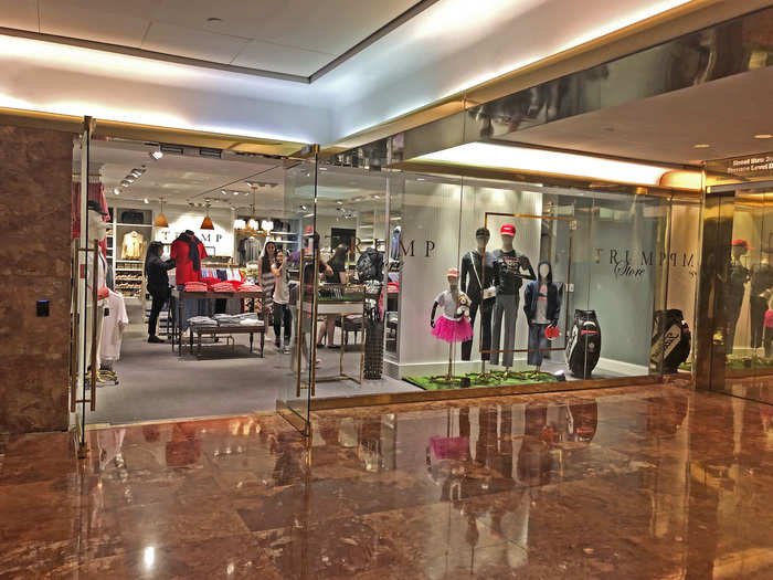 Right at the bottom of the escalator was the bigger store. It had a similar entryway to the one upstairs — floor to ceiling glass with the "Trump Store" decals and mannequins that were ready for a round of golf. But even while I was still a few yards away, I was able to see how much bigger this location was.