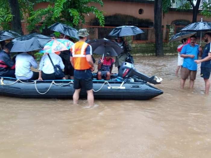 NDRF personnel rescue villagers in Palghar, Maharashtra. Heavy floods have killed 16 people in the state