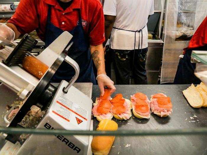 They were sliced to order at lightning speed and layered onto sandwich bread by one crew member.