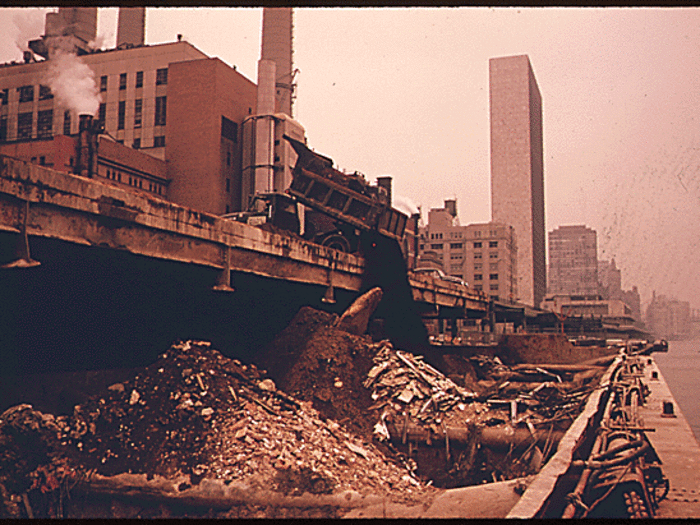 Rubble is loaded into barges before being dumped offshore, on a debris dump site, in the New York Bight. There were different distances for dumping different substances.