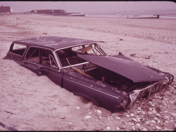 Another car has sunk halfway into the beach at Breezy point, south of Jamaica Bay. The EPA now helps regulate how the city disposes of trash to prevent dumping in the Atlantic.