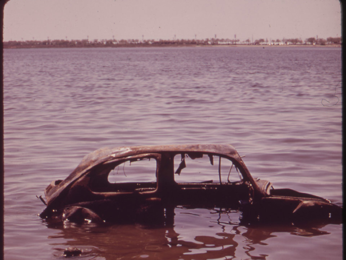 In Jamaica Bay, New York, an abandoned car sits waterlogged in 1973.