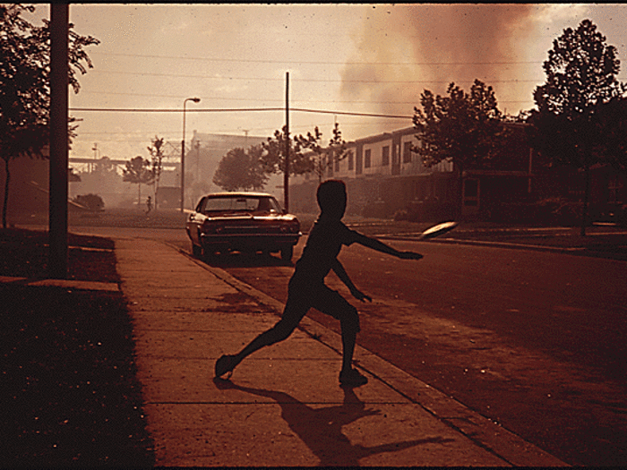 In Birmingham, which truckers in the 1960s called "smoke city", a boy throws a frisbee.