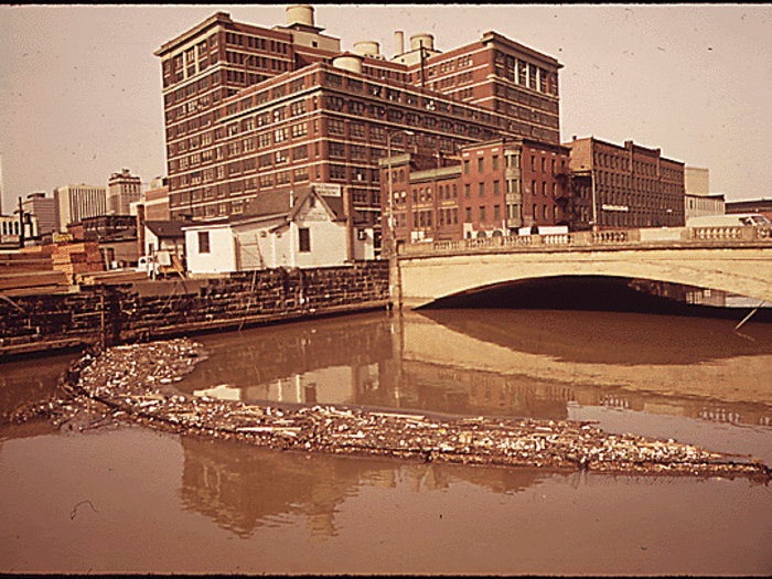 Baltimore City did have some simple techniques to keep the harbor clean. Here, a screen has been placed across the water to trap trash. A heavy rain could break it, but it was effective when cleaned often.