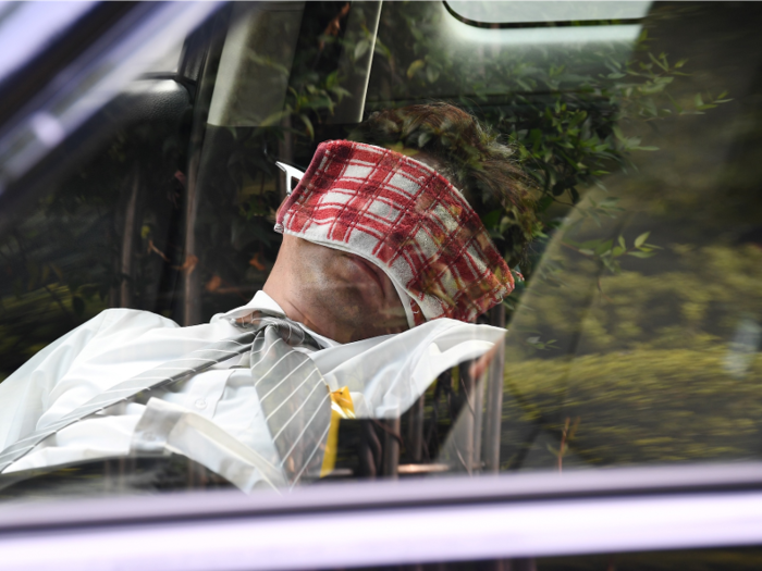 In Japan, a taxi driver takes a nap in his car to make the most of air conditioning.