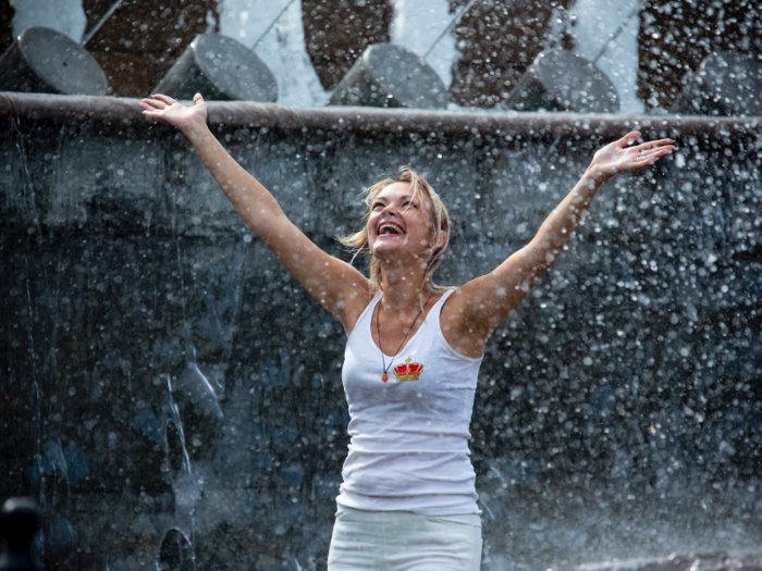 This woman is enjoying a fountain in Alexander Garden in Moscow.