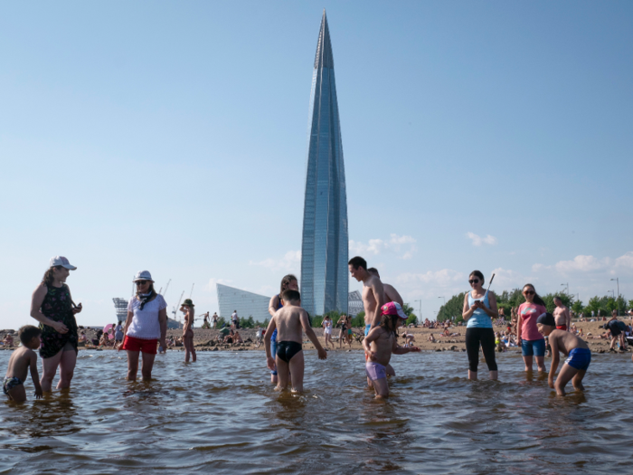 Russia is also melting in the heat. Pictured here are people bathing at a beach in St. Petersburg.