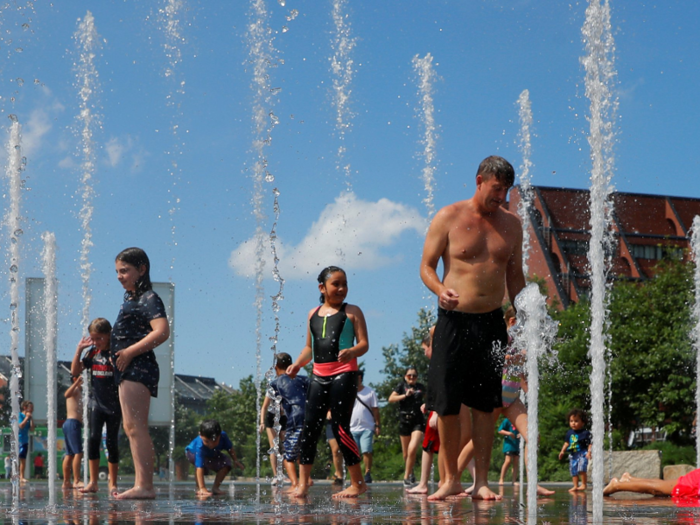 In Boston, kids and adults alike cool off in the fountain on the Rose Kennedy Greenway.